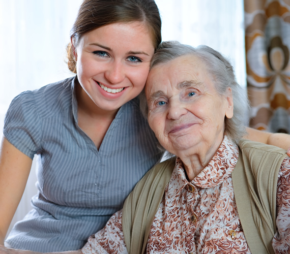 an older lady and her carer smile because Preston Community Transport exist...